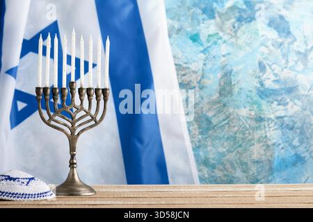 Happy Hanukkah. Hanukkah alte Menorah vor dem Hintergrund der israelischen Flagge mit Sonnenlicht oder Bokeh auf weißem hölzernem Hintergrund. Religionsbild des jüdischen Feiertags Hanukkah-Hintergrunds. Stockfoto