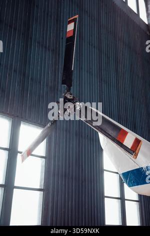 Heckrotor des Hubschraubers. Schwarzer Rotor mit drei Blättern eines alten weißen Hubschraubers in einem Hangar. Stockfoto