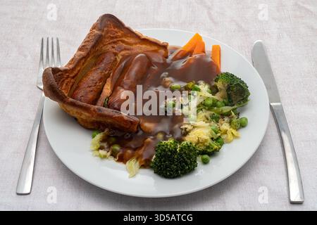 Kröte im Loch Abendessen mit Gemüse und Soße - Würstchen im Teig Stockfoto
