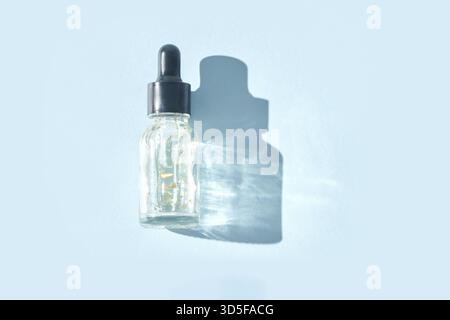 Transparente Flasche mit feuchtigkeitsspendendem Serum mit Pipette. Hautpflegeroutine. Gel Golden funkelt Blasen. Flächenprodukt. Flüssiges Öl. Beauty Vitami Stockfoto
