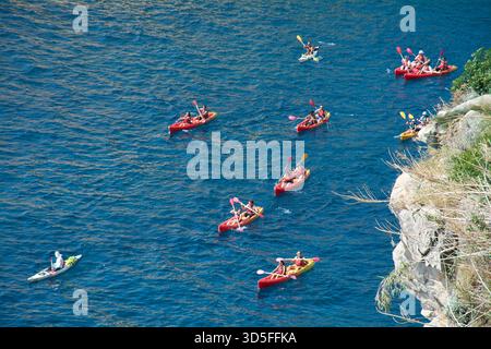 Dubrovnik. Kroatien - 15. November 2025: Aus der Vogelperspektive einer großen Gruppe von Touristen in roten und gelben Kajaks, die auf der Adria paddeln. Beliebter Sommer Stockfoto