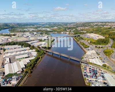 Blaydon on Tyne UK: 15. August 2025: Blaydon Industrial Estate mit verschiedenen Lagerhäusern und Gewerbeobjekten mit alter Eisenbahnbrücke über den Fluss Stockfoto