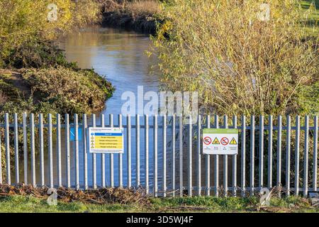Abflusswasser aus dem Kidderminster Flood Linviation Scheme im Feuchtgebiet Stourvale, auch bekannt als Puxton Marsh. Zwei Schilder auf Stahlzäunen, die t erklären Stockfoto