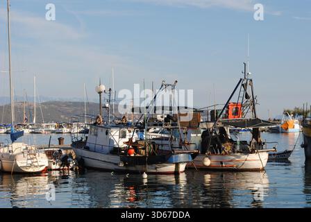 Schiffe mit vielen Farben und Takeleien und ihren bunten Reflexen auf dem Wasser im Hafen von Krk Stockfoto