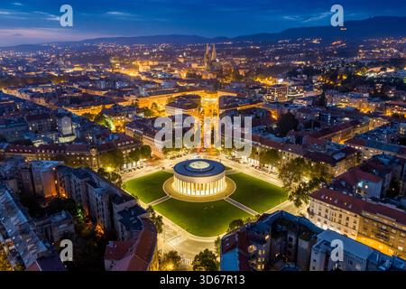 Blick aus der Vogelperspektive auf den beleuchteten Meštrović Pavillon, der stolz inmitten des städtischen Glanzes der Stadt in der Dämmerung steht, Zagreb, Kroatien. Stockfoto