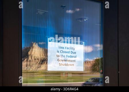 Badlands National Park, South Dakota – die Felsformationen der Badlands spiegeln sich in der Tür des Badlands National Park Visitor Center. Ein Schild ankündigt Stockfoto