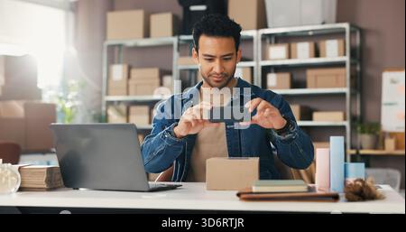 Geschäftsmann, Laptop und Telefon mit Box für Liefertermine, Nachverfolgung oder Scannen im Lager. Mann, Mitarbeiter oder Foto mit Handy-Smartphone, Paket Stockfoto