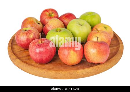 Rote und grüne Äpfel auf einem runden Holztablett Stockfoto