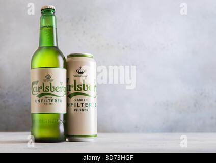 LONDON, UK - 25. NOVEMBER 2025: Flasche und Aluminiumdose von Carlsberg ungefiltertem Lagerbier auf Lichttisch. Stockfoto