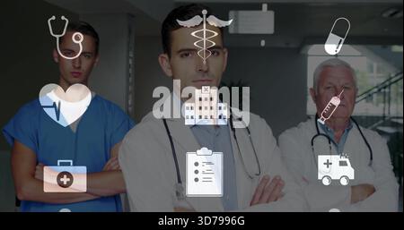 Stehender leitender Arzt und Team überqueren Arme im Klinikkorridor, zeigen Labormäntel und medizinische Ikonen Stockfoto