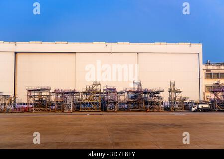 Ein Flugzeughangar mit geschlossenen Türen und in der Nähe befindlichen Hilfsstützen und Landeplätzen. Stockfoto