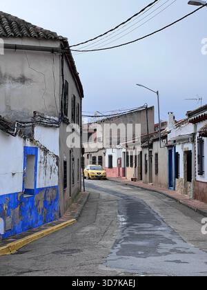 Eine ruhige Dorfstraße in Puerto Lapice, La Mancha, Spanien, zeigt traditionelle ländliche Häuser und den Alltag in einem kleinen spanischen Dorf. Stockfoto
