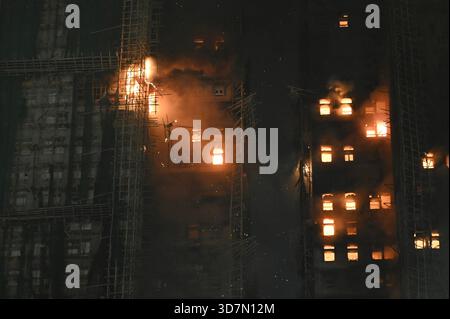 Hongkong, Hongkong. November 2025. Rauch und Flammen steigen auf, als ein Großbrand am 26. November 2025 mehrere Wohngebäude am Wang Fuk Court in Hongkong erfasst. Das Serval Wohngebäude im Wang Fuk Court im Tai Po District hat heute Feuer gefangen. Die Hong Kong Feuerwehr hat den Feueralarm Nr. 5 ausgegeben, der Brand zur lokalen Zeit sind 2300 13 Menschen tot und 30 verletzt nach Angaben der Regierung. (Foto: Kobe Li/Nexpher Images/SIPA USA) Credit: SIPA USA/Alamy Live News Stockfoto