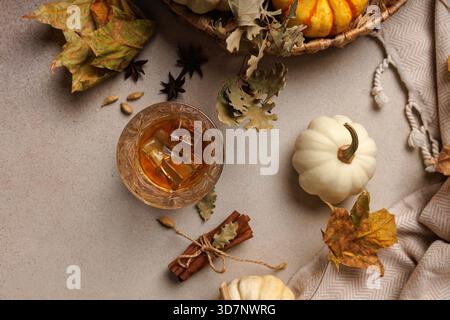 Whiskey mit Eis und Zimt auf Herbsttisch. Stockfoto