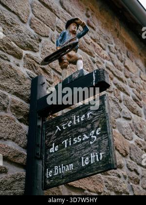 Ein geschnitztes hölzernes Ladenschild in der Gemeinde Locronan im Département Finistère der Bretagne im Nordwesten Frankreichs. EU Stockfoto
