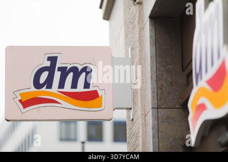 Bamberg, Deutschland 27. November 2025: Im Bild: Armschild und Fassadenlogo einer dm Drogerie in der Bamberger Innenstadt. Das Foto zeigt das Branding des Einzelhändlers auf der Gebäudefassade und damit eine typische Szene aus dem lokalen Einzelhandel und der Ökonom Stockfoto