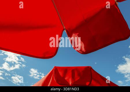 Roter Sonnenschirm vor blauem Himmel, Grindelwald, Zwitserland Stockfoto