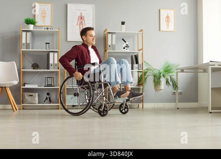 Behinderter Mann sitzt im Rollstuhl, ruht zu Hause, Rehabilitation nach Verletzung, männlicher Patient Stockfoto