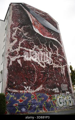 Berlin, Deutschland. Steakgemälde, Berlin 1961-1989. Großes Wandgemälde des deutschen Künstlers Marcus Haas, nachdem er den Wettbewerb „If Walls Could Talk“ gewonnen hatte, der 2016 von der Kunstgruppe Xi-Design gefördert wurde. Das Hotel befindet sich in der Bernauer Straße 11, neben der Berliner Mauer-Gedenkstätte. Sie symbolisiert die Teilung, die durch die Mauer verursacht wurde. Die Textur des Fleisches repräsentiert die verschiedenen Stadtviertel, die mit einem Messer in zwei Hälften geschnitten werden. 989. Die Regierung der Deutschen Demokratischen Republik (DDR) errichtete diese über 150 km lange Barriere, um Ost-Berlin vollständig von der übrigen DDR zu isolieren. Gedenkstätte Berliner Mauer in der Bernauer Straße Stockfoto