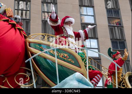 Santa Claus, Mrs. Claus und Elfen, die auf dem Santas-Schlitten während der jährlichen Thanksgiving-Day-Parade am 27. November 2025 in New York City gesehen wurden. Stockfoto