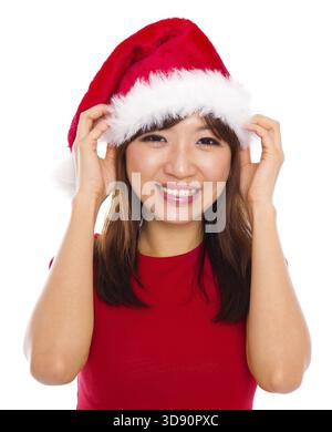 Schöne asiatische Frau in Weihnachten Santa Klausel roten Hut lächelnd, isoliert auf weißem Hintergrund Stockfoto