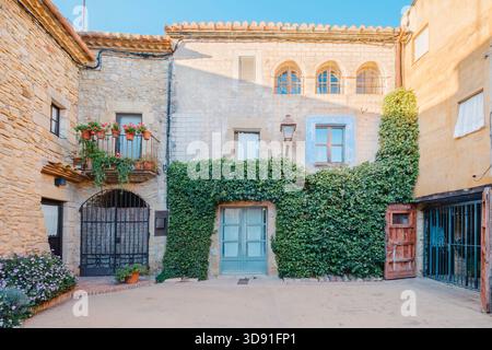 Mittelalterliche Steinfassade an einem ruhigen Stadtplatz in Peratallada, Girona, Katalonien, Spanien Stockfoto