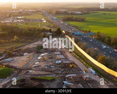 WARRINGTON, CHESHIRE, ENGLAND – 17. NOVEMBER 2025: Wohngebäude mit einer akustischen Barriere entlang der Autobahn M62 in Warrington, England. Stockfoto