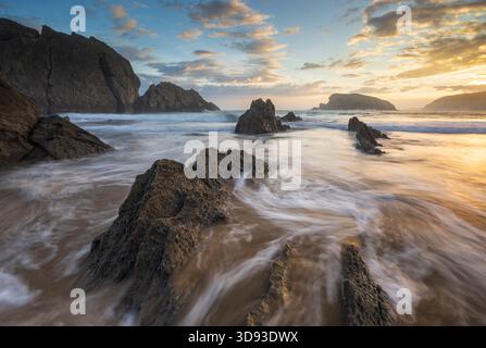 Sonnenaufgang über dem Strand an Playa de la Arnia an der Costa Quebrada, Kantabrien, Spanien. Herbst (September) 2025. Stockfoto