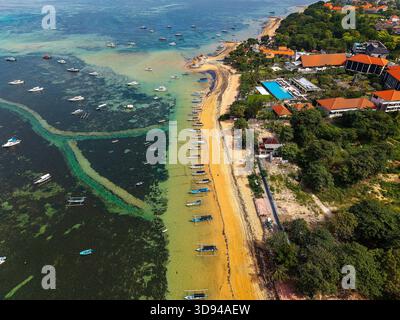 Blick auf traditionelle Boote am Strand von Sanur und Yachten im Meer Stockfoto