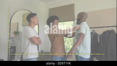 Messstylist mit Maßband an bärtigen Männern im Boutique-Fitting-Bereich Stockfoto