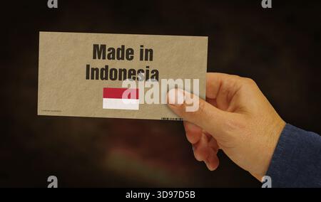 Hergestellt in Indonesien Box in Hand. Indonesischer Export Import Herstellung und Lieferung. Produktfabrik, Import und Export. Abstraktes Konzept 3D Illustrati Stockfoto