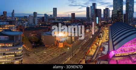 Panoramablick bei Dämmerung auf die Bridgewater Hall neben Manchester Central vor der modernen Skyline der Stadt und den Winterlichtern. Stockfoto