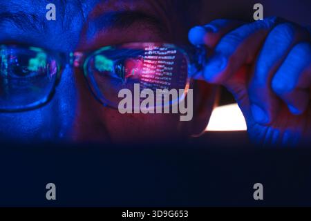 Person, die Finanzdiagramme und Kryptowährungsinformationen anzeigt, die sich in korrigierenden Brillen widerspiegeln Stockfoto