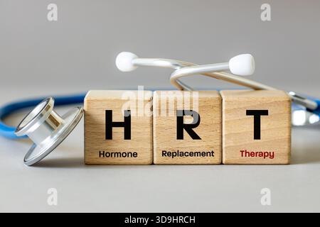 Medizinisches HRT-Symbol. Hormonersatztherapie. Gesundheitskonzept. Hormonmangelergänzung. Menopause-Symptomlinderung. Auf Holzblock geschrieben Stockfoto