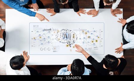 Ein dynamisches Team von Fachleuten nimmt an einem gemeinsamen Meeting Teil, das sich auf Konzepte der künstlichen Intelligenz konzentriert und moderne Datentechnologien nutzt Stockfoto