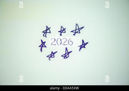 Ein sauberes und festliches Foto mit dem handgeschriebenen Satz „Happy New Year 2026“ auf weißem Hintergrund, perfekt für Weihnachtsgrüße, Karten, Banner, Stockfoto
