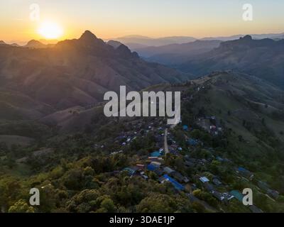 Friedlicher Blick aus der Luft auf das Bergdorf bei Sonnenuntergang. Wunderschöne Landschaft und Naturlandschaft mit Sonnenuntergang über Tal und Hügel. Ruhig und abgelegen l Stockfoto