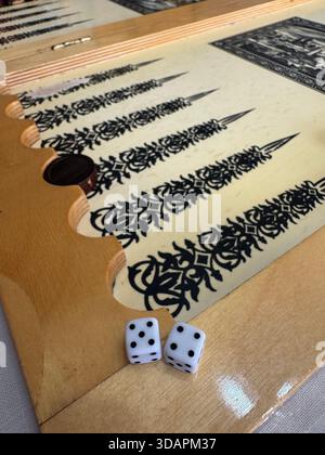 Blöcke auf hölzernem Hintergrund. Zugeschnittenes Bild von Backgammon, der auf einem Holzbrett über weißem Hintergrund spielt. Brett für ein Spiel Backgammon auf einem Stockfoto