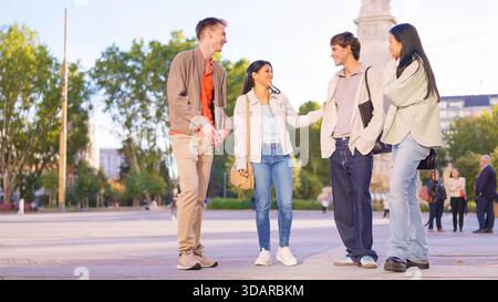 Verschiedene Freundesgruppen, die sich im Freien in der Stadt unterhalten Stockfoto