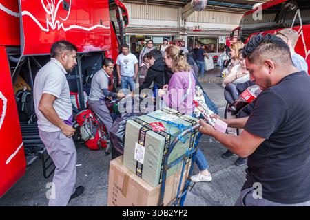 Puebla Mexico, CAPU Central de Autobuses de Puebla Busbahnhof, ADO Intercity Bus Plattform, Menge von Passagieren Männer Frauen Erwachsene mit rollendem Gepäck, tra Stockfoto