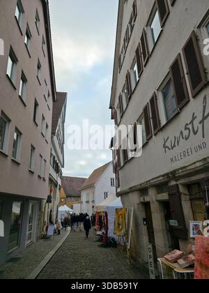 Nürningen, Deutschland, 13. Dezember 2025, beliebter weihnachtsmarkt in der Altstadt mit vielen Menschen, die die Adventszeit bei Tageslicht genießen Stockfoto