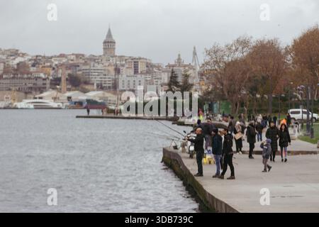 Stadtansicht von Istanbul: Fischer am Ufer mit Blick auf das Beyoglu-Viertel und den Galata-Turm Stockfoto