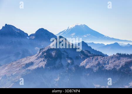 Ein malerischer Blick vom Skyline Trail aus fängt die markanten, blau gefärbten Mazama Ridge Berge mit dem hoch aufragenden, schneebedeckten Mount Adams in t ein Stockfoto