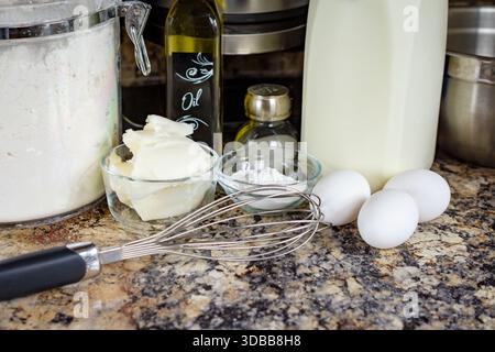 Waffelzutaten auf einer Küchentheke, mit Mehl, Eiern, Milch, Öl, und Kürzung für ein hausgemachtes Frühstücksrezept im Waukesha County. Stockfoto