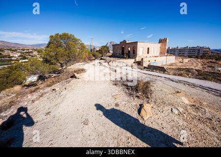 Ein Weitwinkelblick auf den trockenen Pfad, der zur verlassenen Villa Giacomina und zum Malladeta-Turm in Villajoyosa führt, mit dem langen Sch des Fotografen Stockfoto
