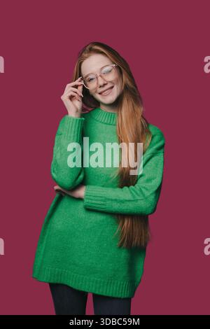 Nachdenkliche blonde Frau mit Brille in gemütlicher Umgebung Stockfoto