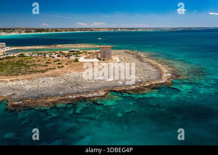 Blick aus der Vogelperspektive auf Torre Lapillos historischen Wachturm, der Wächter vor dem türkisfarbenen Meer steht, einer zerklüfteten Küste, die auf den azurblauen Horizont trifft, Torre La Stockfoto