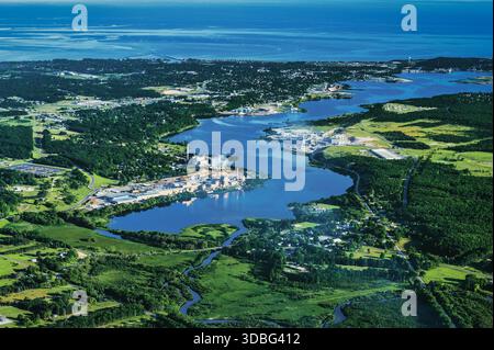 Entdecken Sie die atemberaubende Luftfotografie des Manistee Lake und seiner umliegenden Industrie, die an einem sonnigen Nachmittag Natur und menschlichen Einfallsreichtum zeigt. Stockfoto