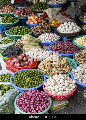Blick auf die lebendige Auswahl an Obst und Gemüse, die aus gewebten Körben platzen, einen Wandteppich aus Texturen und Farben in einer belebten Marktszene, Hanoi, Hanoi Stockfoto