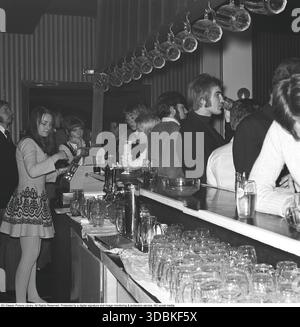 Die Leute in der Bar 1969. Eine junge Frau steht hinter der Bar und serviert den Leuten Getränke und Bier. Kristoffersson Ref. EB147-3 Stockfoto